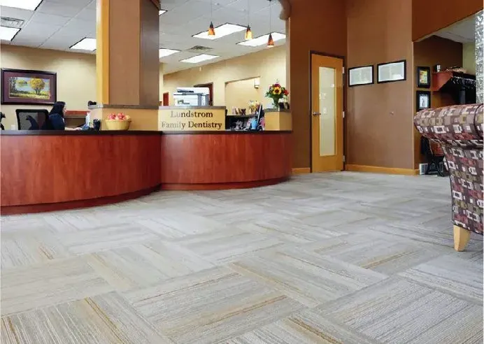 Office reception desk surrounded by patterned carpet tile