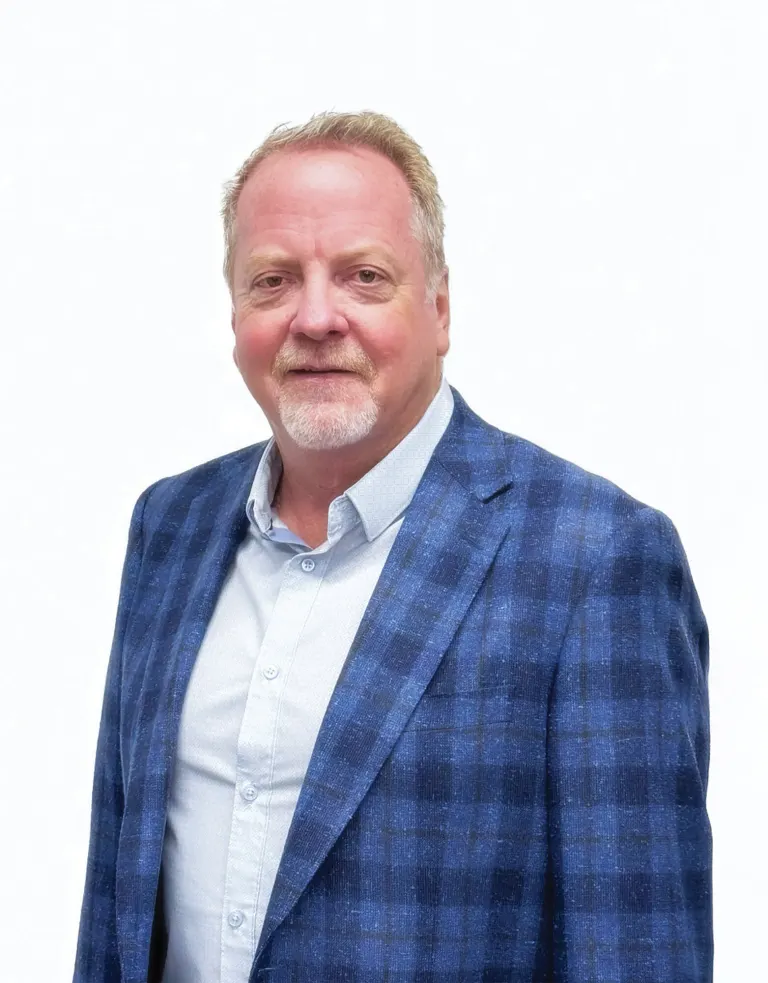 Kevin Christianson smiling in a blue plaid blazer and light blue shirt against a white background.