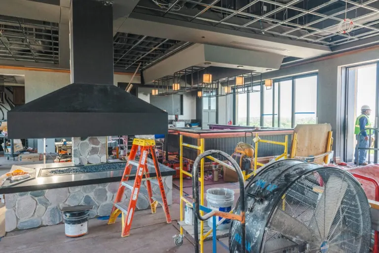 “This is kind of quadranted out into four distinct spaces,” Brantner said. “We have a wine room. We have a sitting area. We have a full commercial-grade kitchen so we can make meals. There’s a dining area. There are two 85-inch TVs, and a full bar.…