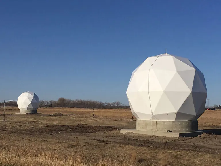Satellite dishes encased in white domes sit on the edge of Lanny's property, locking onto passing satellites for ten-minute bursts, capturing imagery of the United States and beyond.