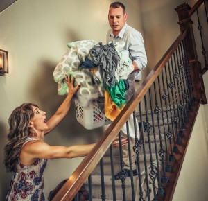 Overloaded Laundry Service Emily Hearn and Jason Hearn Moorhead Business owners going down stairs