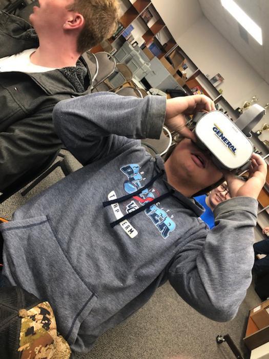 A student watches the virtual reality video.